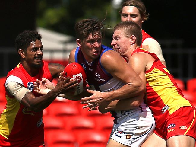 Josh Clayton (centre) playing for the Brisbane Lions at the Metricon Stadium. Photo: Regi Varghese