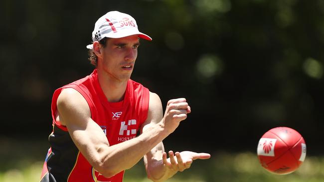 Ben King handballs during a Gold Coast Suns AFL training session.