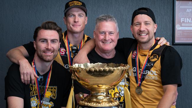 Paul Sandercock with the SANFL premiership cup and Glenelg’s past three Jack Oatey Medallists, from left, Liam McBean, Lachie Hosie and Matthew Snook. Picture: Naomi Jellicoe