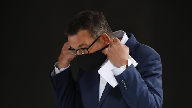 Premier Daniel Andrews puts on his mask after speaking to the media during a press conference in February 2021. Picture: Daniel Pockett