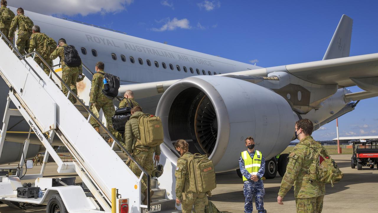 Air force and Army personnel board a waiting KC-30A Multi-Role Tanker Transport aircraft at RAAF Base Amberley to support evacuation efforts in Afghanistan.