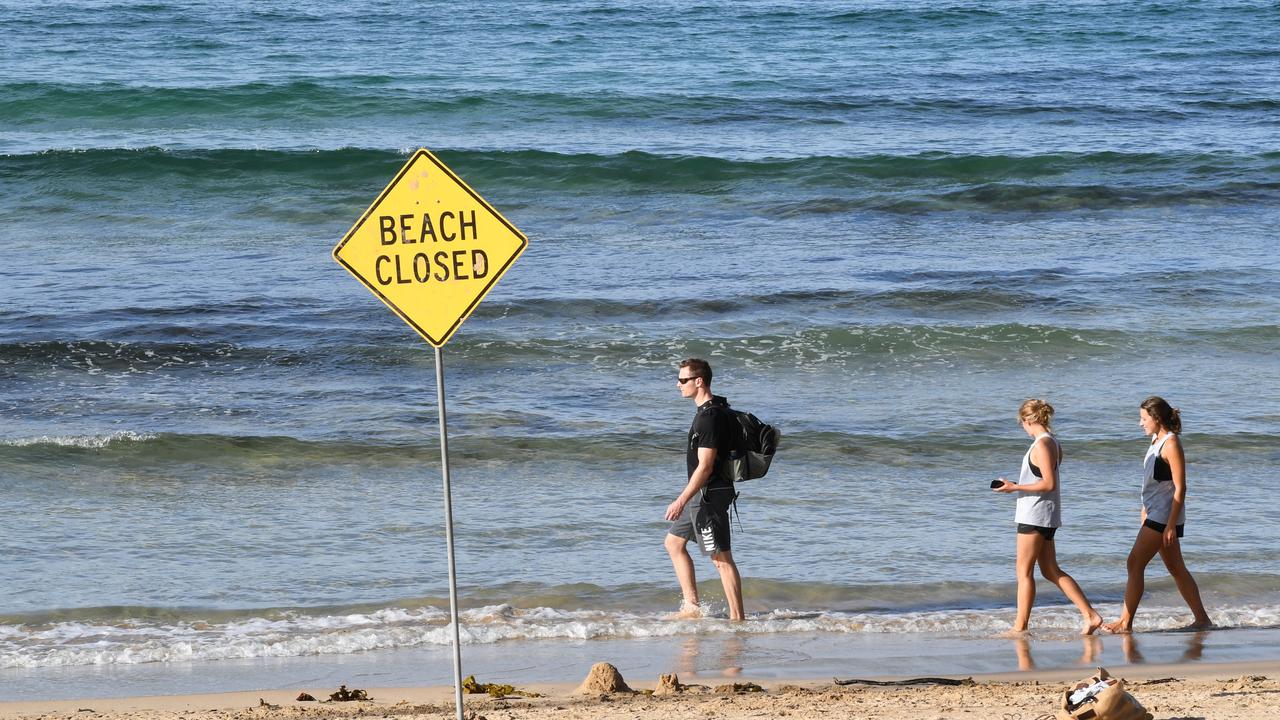 People ignoring the closed beach signs and social distancing rules at Manly Beach at the weekend. Picture: Getty Images