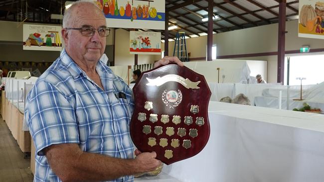 Chris Garrett with a memorial shield in the main pavilion at Macksville Showground. Picture: Chris Knight