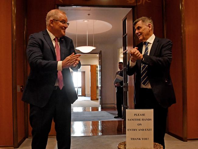 Prime Minister Scott Morrison and Chief Medical Officer for the Australian Government Professor Brendan Murphy sanitise their hands on arrival for a National Cabinet meeting at Parliament House. Picture: Getty