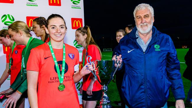 South Hobart Womens Super League Captain, Sophie Westwood is presented with the Statewide Cup trophy by Football Tasmania President, Bob Gordon. Picture: Linda Higginson/Football Tasmania