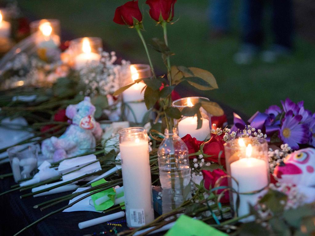 Tributes were laid at a vigil in Santa Fe, Texas for the victims of the mass shooting. Dimitrios Pagourtzis, the 17-year-old shooter, is being held on capital murder charges, meaning he could face the death penalty. / AFP PHOTO