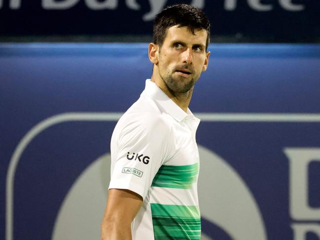 Serbia's Novak Djokovic reacts to his defeat by Czech Republic's Jiri Vesely during their quarter-final match at the ATP Dubai Duty Free Tennis Championship, in the Gulf emirate on February 24, 2022. (Photo by Karim SAHIB / AFP)