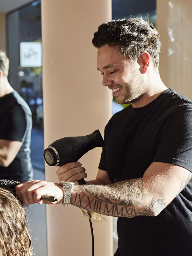 Cole at work in his new salon.