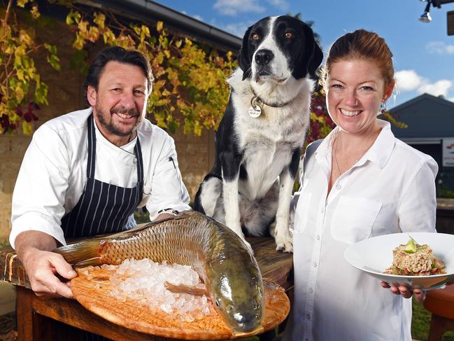 05/06/18 - Ollfactory Inn's Simon Burr, partner Lauren Alexander and dog Edie.  Pictured at their Strathalbyn restaurant with a fresh whole carp and a plated dish of carp.Picture: Tom Huntley