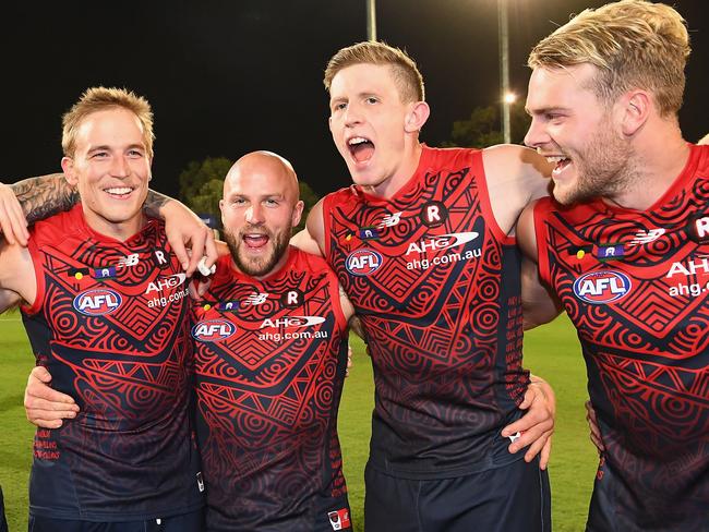 ALICE SPRINGS, AUSTRALIA - MAY 27:  James Harmes, Bernie Vince, Nathan Jones, Sam Frost and Jack Watts of the Demons sing the song after winning the round ten AFL match between the Melbourne Demons and the Gold Coast Suns at Traeger Park on May 27, 2017 in Alice Springs, Australia.  (Photo by Quinn Rooney/Getty Images)