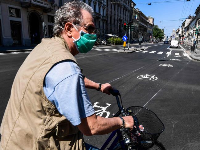 A man rides a bicycle through central Milan as Italy starts to ease its lockdown. Picture: AFP