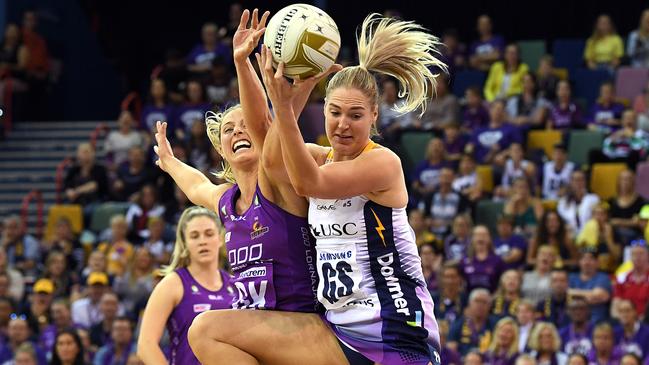 Laura Geitz of the Firebirds, left, competes for the ball with Lightning’s Caitlin Bassett. Picture: AAP