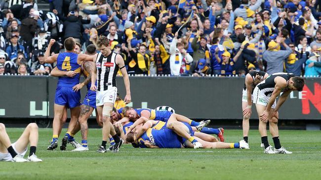 Collingwood players looked defeated on the final siren as the Eagles players celebrated. Picture: David Caird