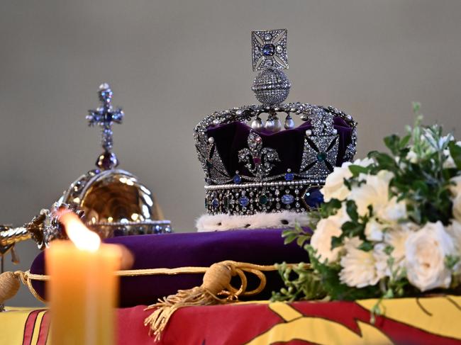 LONDON, ENGLAND - SEPTEMBER 14: The coffin of Queen Elizabeth II, draped in a Royal Standard and adorned with the Imperial State Crown with the Imperial State Crown and the Sovereign's orb and sceptre, is pictured inside at Westminster Hall on September 14, 2022 in London, England. Members of the public are able to pay respects to Her Majesty Queen Elizabeth II for 23 hours a day from 17:00 on September 14, 2022 until 06:30 on September 19, 2022.  Queen Elizabeth II died at Balmoral Castle in Scotland on September 8, 2022, and is succeeded by her eldest son, King Charles III. (Photo by Marco Bertorello - WPA Pool/Getty Images)