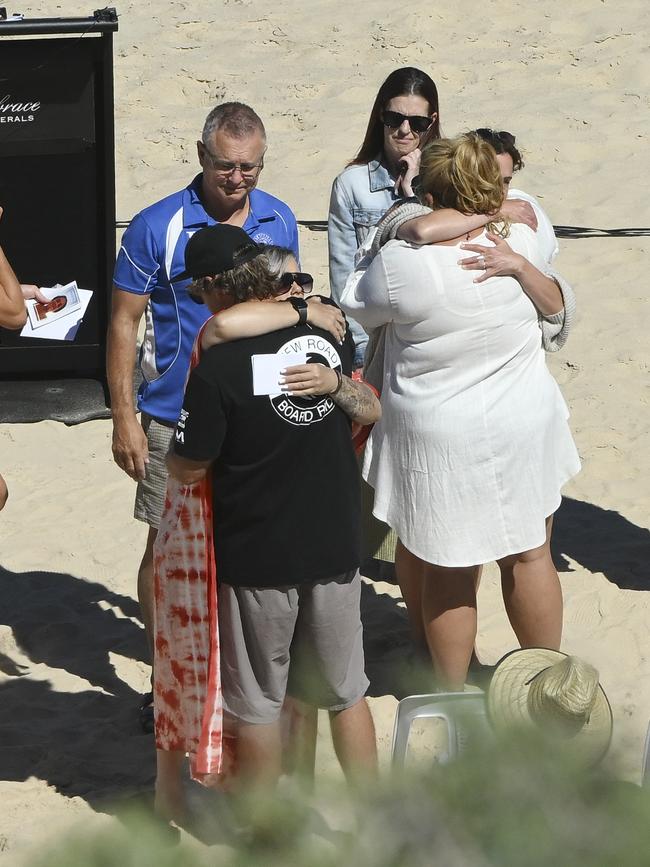 The parents of Khai Cowley hug friends and mourners as they arrive for his funeral service Picture: NCA NewsWire / Mark Brake