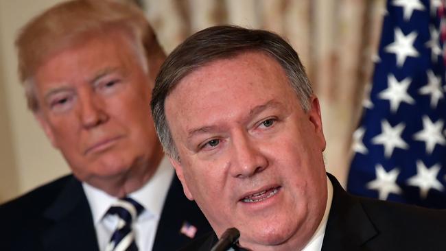 President Donald Trump watches Mike Pompeo speak at the State Department in Washington.