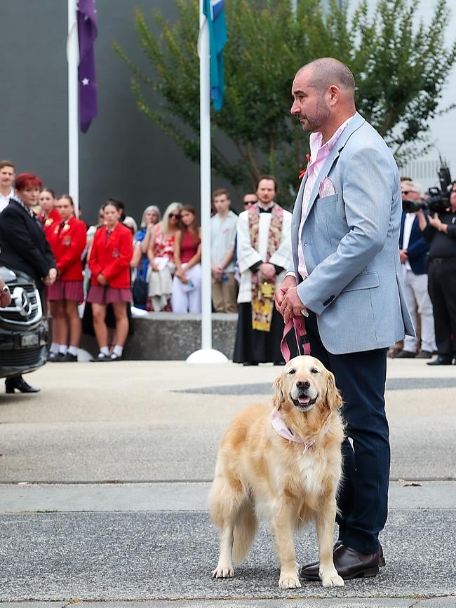 Mark Jones holds onto Zara the family dog at Bianca’s funeral. Picture: NewsWire/Ian Currie.