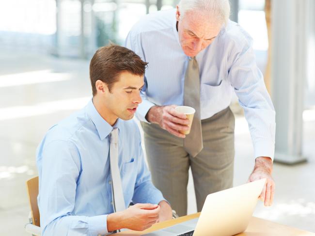 Cropped shot of two businessmen discussing information on a laptop