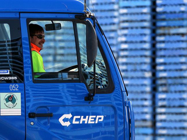 A worker sits inside a truck at Brambles Ltd.'s CHEP pallet service center outside Melbourne, Australia, on Monday, Aug. 17, 2009. Brambles Ltd., the world's biggest supplier of pallets used to move and store goods in factories, will announce full-year earnings on Aug. 20, 2009. Photographer: Luis Enrique Ascui/Bloomberg