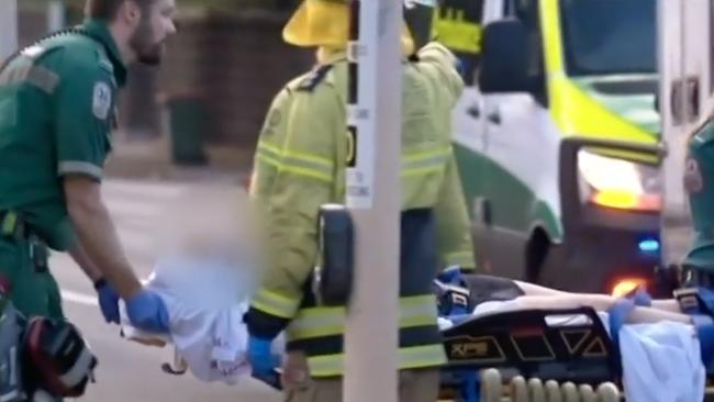 One of the seriously injured students, then aged 16, is treated and transported by paramedics at the scene. Picture: 7NEWS