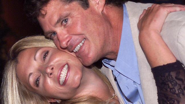 ** FILE ** Pamela Bach, left, poses with husband David Hasselhoff in this Aug. 11, 2000 file photo in Los Angeles.  Less than a month after filing for divorce, Bach, the estranged wife of Hasselhoff, is alleging that the former "Baywatch" star abused her, according to court records. (AP Photo/Jill Connelly, File)