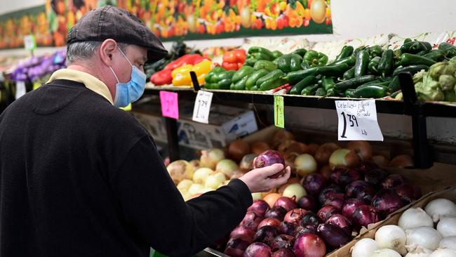 A customer browses produce at a stall inside Grand Central Market in downtown Los Angeles as US consumer prices hit a new 40-year high in February 2022. Picture: AFP