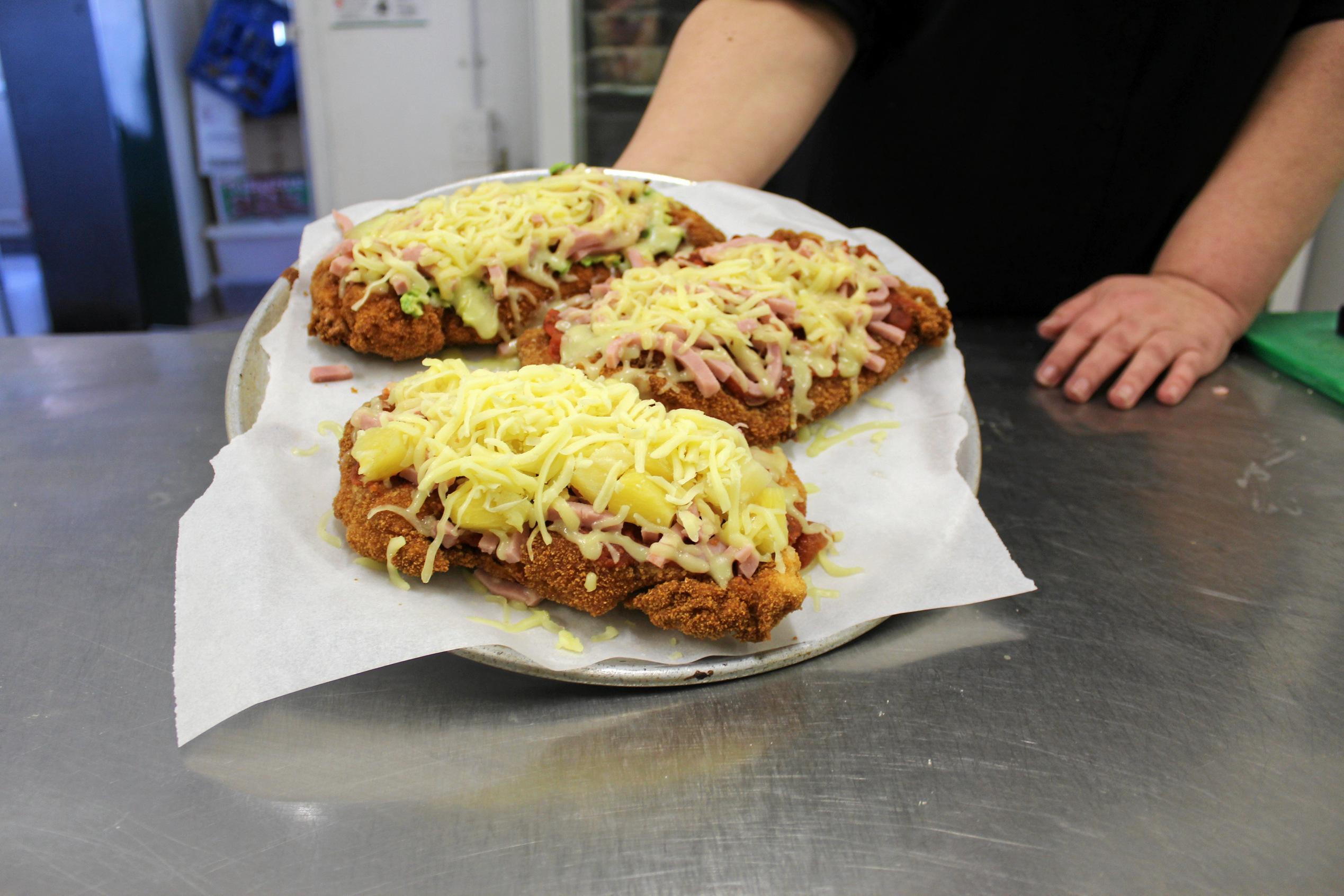 Customers love the generous serving sizes of the chicken parmies served up at the Royal Hotel in Yarraman. Picture: Laura Blackmore