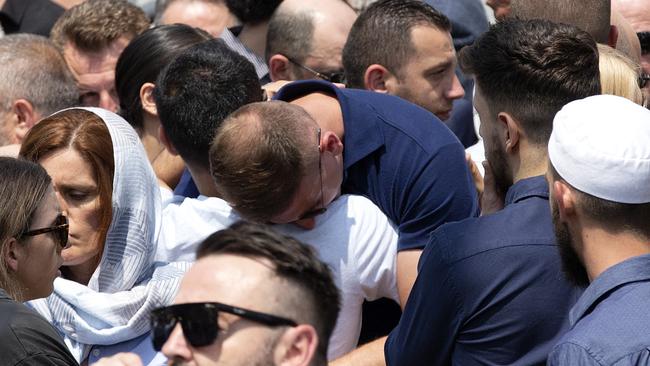 Mourners console each other as they farewell newlyweds Venton and Lindita Musai. Picture: Sarah Matray