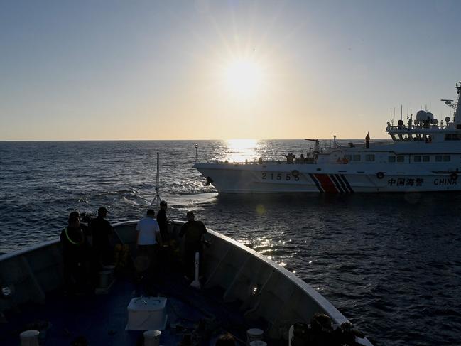 This photo taken on March 5 shows a China Coast Guard vessel sailing in front of Philippines’ BRP Sindangan during a supply mission to Second Thomas Shoal in the disputed South China Sea. Picture: AFP