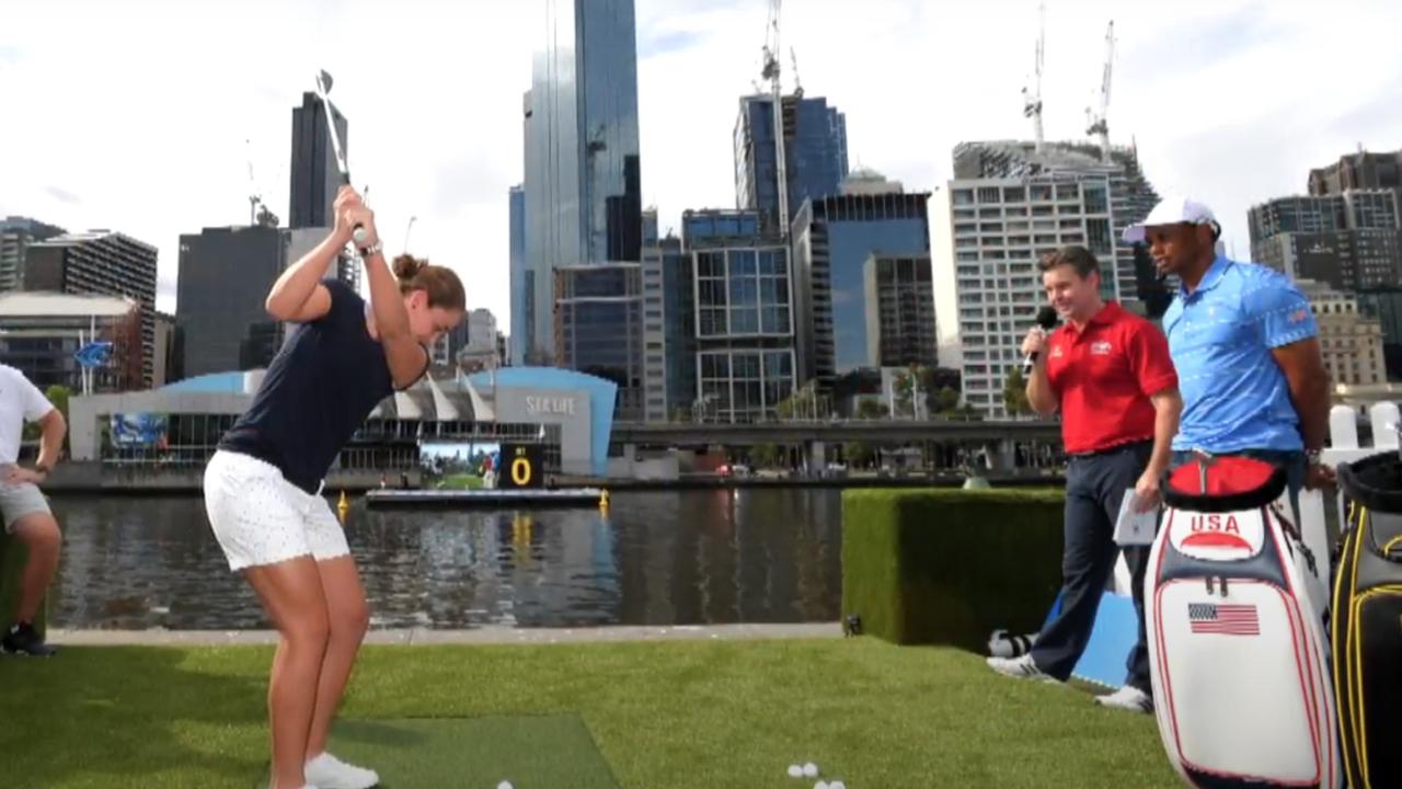 Ash Barty strikes a ball into the Yarra River in front of Tiger Woods. Photo: Fox Sports.