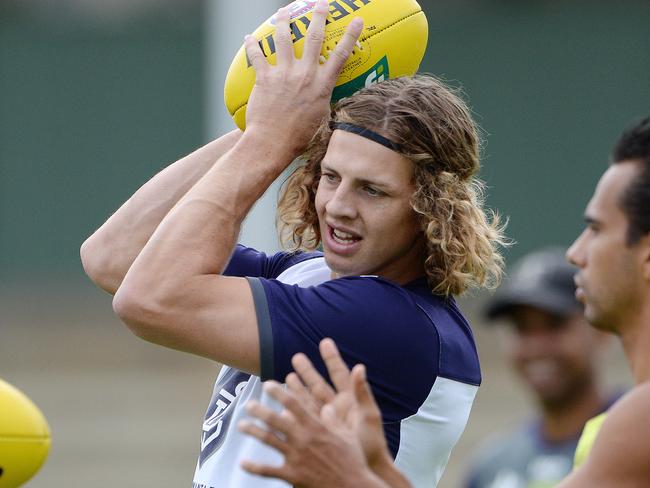 SPORT - The Fremantle Dockers train ahead of their season opener on Sunday. Photo by Daniel Wilkins. PICTURED- Nathan Fyfe does a handball drill