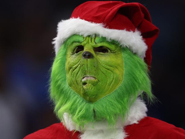 DETROIT, MICHIGAN - DECEMBER 11: A fan dressed as The Grinch looks on from the stands during the first half in the game between the Minnesota Vikings and Detroit Lions at Ford Field on December 11, 2022 in Detroit, Michigan.   Rey Del Rio/Getty Images/AFP (Photo by Rey Del Rio / GETTY IMAGES NORTH AMERICA / Getty Images via AFP)