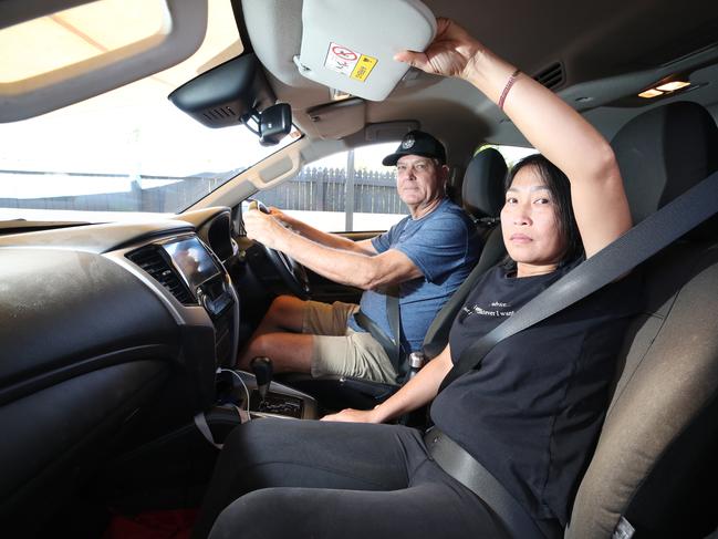 Ms Nyugen demonstrates how her arm briefly slipped away from her seatbelt as she reached for the sun visor. Picture: Glenn Hampson.