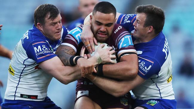 Canterbury's Brett and Josh Morris tackle Manly's Dylan Walker. Picture. Phil Hillyard