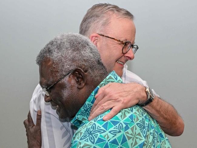 Australia's Prime Minister Anthony Albanese (back) hugs Solomon Islands Prime Minister Manasseh Sogavare as they meet for a bilateral meeting at the Pacific Islands Forum (PIF) in Suva on July 13, 2022. (Photo by Joe Armao / POOL / AFP)