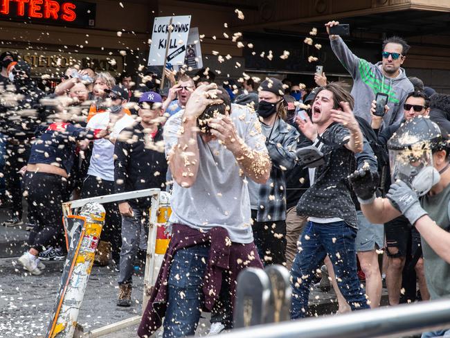 Police spray OC foam into the crowd near Flinders St Station. Picture: Sarah Matray