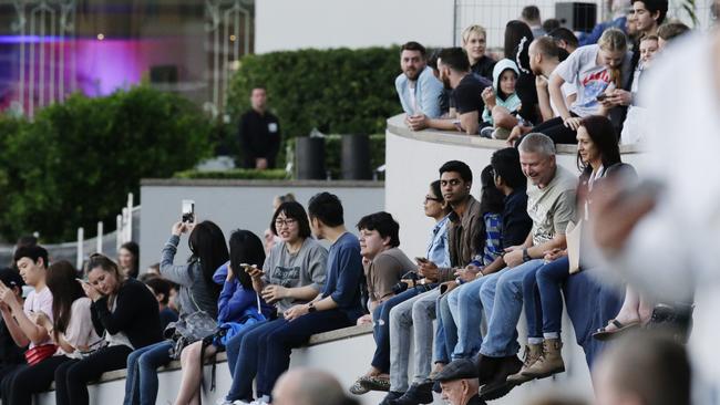 Crowds gather on Brisbane’s Riverwalk to catch the spectacle. Picture: Lachie Millard