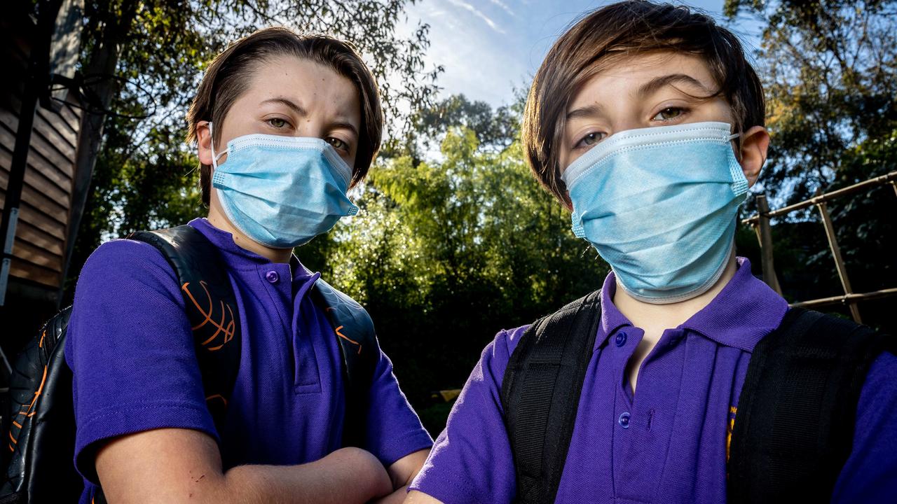 Felix and Oliver wear masks to school. Picture: Jake Nowakowski