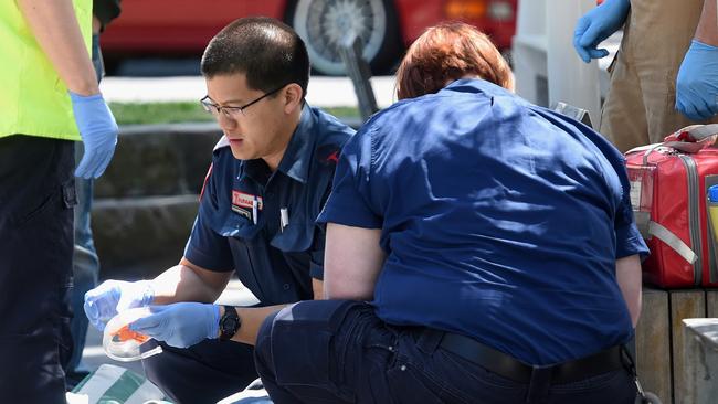 Paramedics work on a man for a suspected overdose on Lennox street. Picture: Nicole Garmston