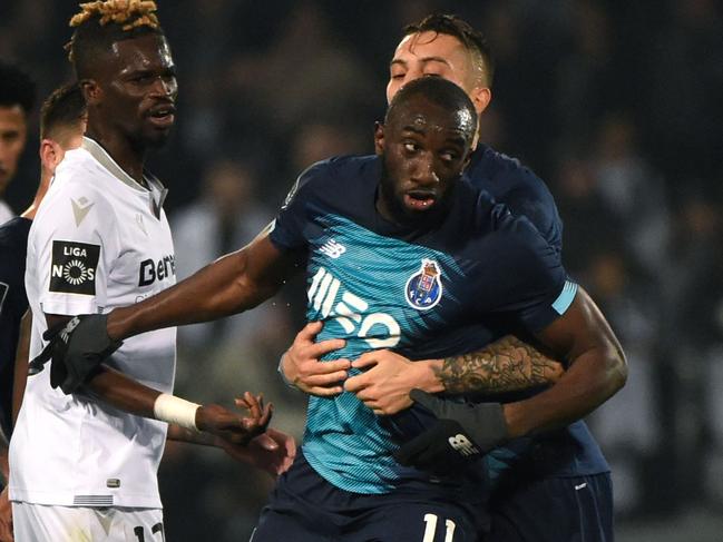 FC Porto's Malian forward Moussa Marega (C) reacts and attempts to leave the pitch after hearing racists chants as FC Porto's Brazilian defender Alex Telles tries to stop him during the Portuguese league football match between Vitoria Guimaraes SC and FC Porto at the Dom Alfonso Henriques stadium in Guimaraes on February 15, 2020. (Photo by MIGUEL RIOPA / AFP)