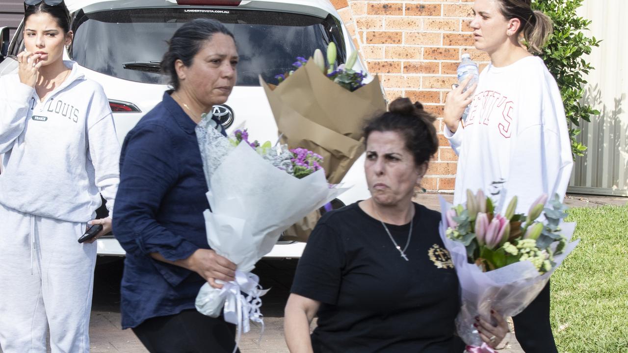 People pictured bringing flowers to the Christ The Good Shepherd Church in Wakeley. Picture: NCA NewsWire / Monique Harmer