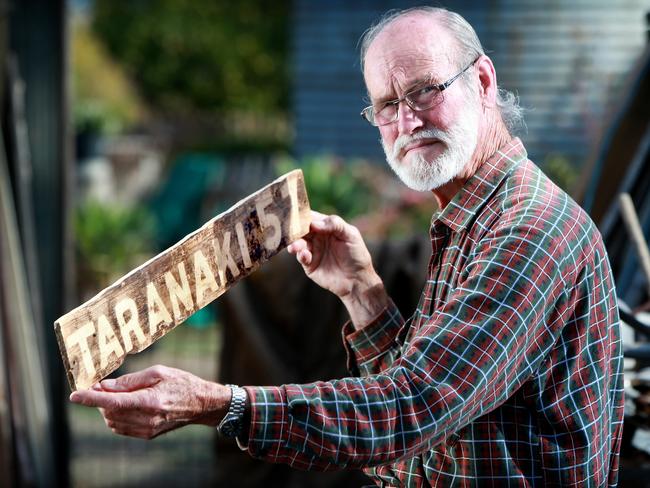 Maralinga nuclear test victim Avon Hudson at his Balaklava home with a sign from one of the sites.