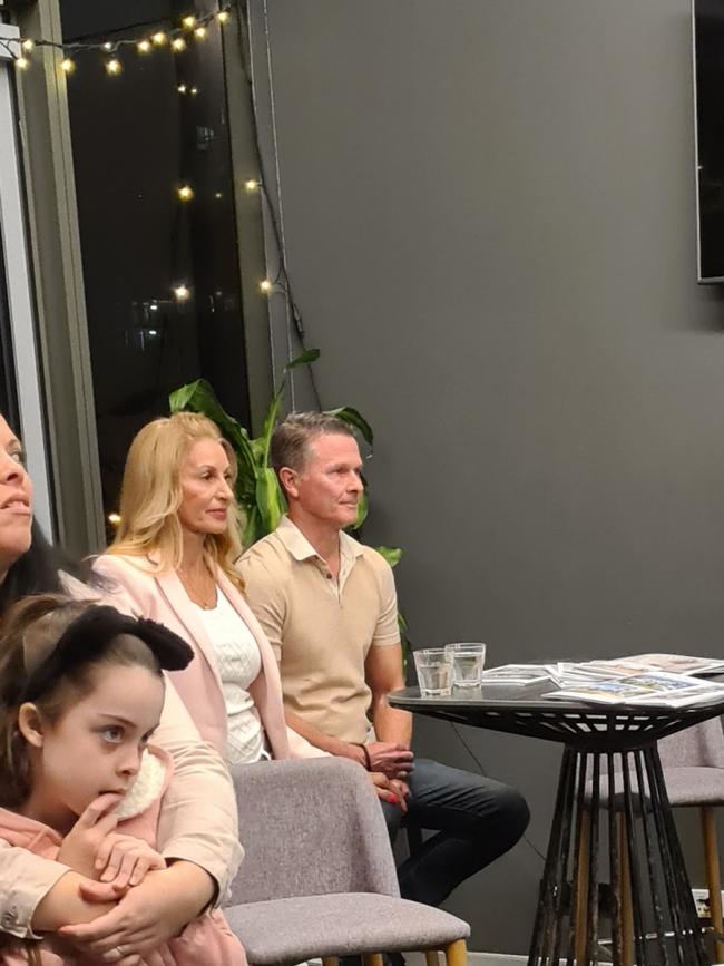 Matthew and Amanda Clarkson (seated far table) attend an auction on May 6, 2021, for their property at 38 Seashell Ave, Mermaid Beach