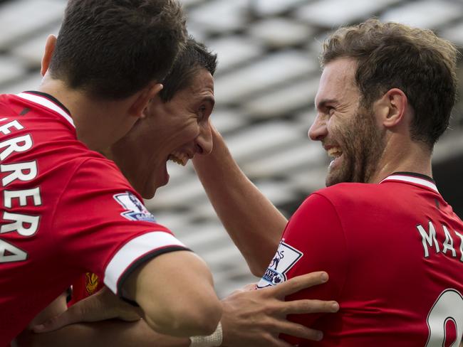 Manchester United's Juan Mata, right, celebrates with teammates.