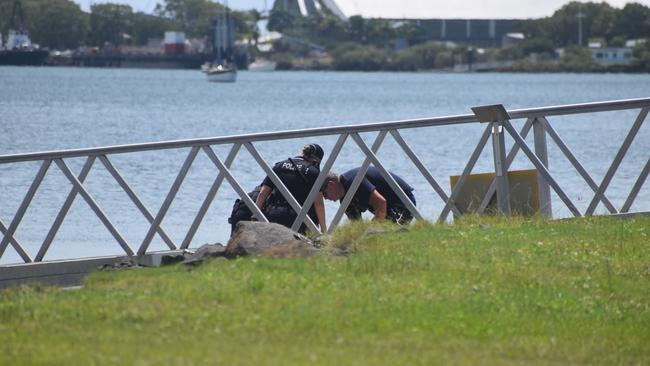 Police investigate the scene on the banks of the Burnett River and interview boaties following a serious boat crash.