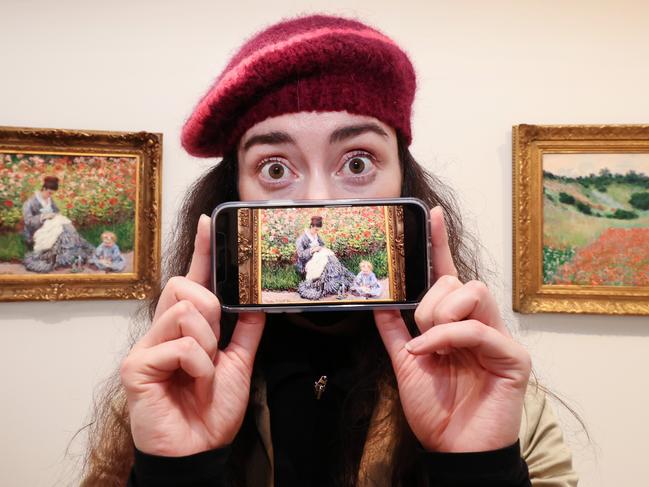 NGV RE-OPENS with blockbuster Melbourne Winter Masterpieces 2021 exhibition: French Impressionism from the Museum of Fine Arts, Boston. Art lover Matilda McKenna excited about getting a photo of one of her favourite paintings by French artist Claude Monet of Camille Monet and child, one of 16 in the curved room.                     Picture: David Caird