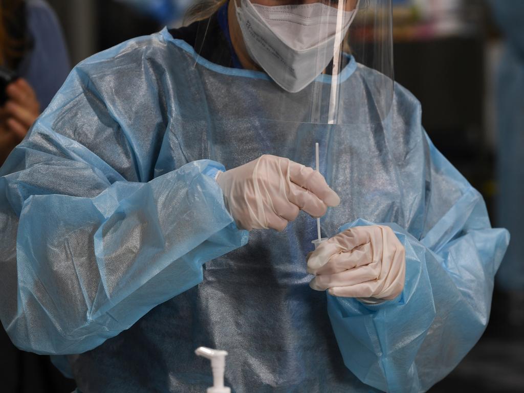 A health worker preparing a swab at Histopath Diagnostic Specialists at Sydney International Airport. Picture: James D. Morgan/Getty Images