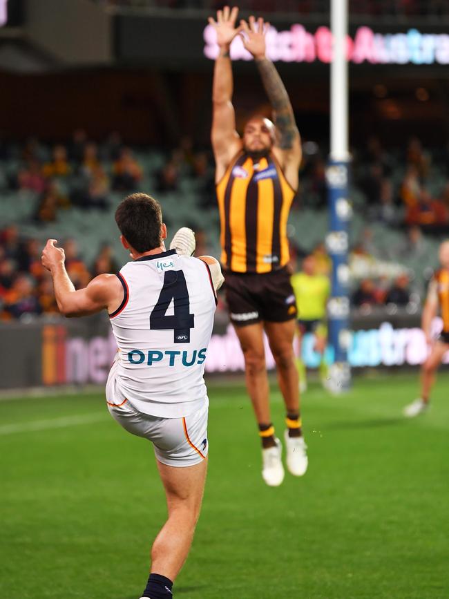 Lachlan Murphy kicks a goal over Jarman Impey at Adelaide Oval