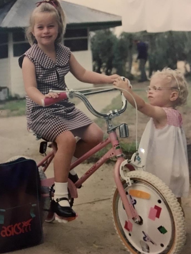 Alex, setting out for school, and doting little sister Virginia in 1993.