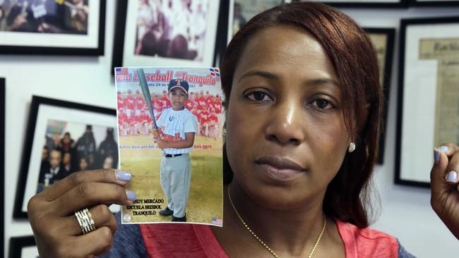 Maribel Martinez holds a photo of her son Andy at her attorney's office. Picture: AP.